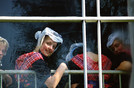 Staphorst 1986 'young women in Sunday costumes behind church window'