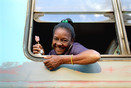 Cuba Cienfuegos Prov. Woman in train with ice lolly.