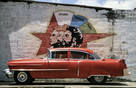 Cuba Ciego d'Avila 'an American chevy before a political wallpainting'